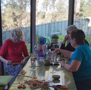 Three family members doing craft at a table