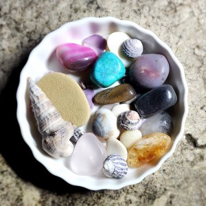A bowl of crystals and shells to be placed under a full moon for energetic cleansing.